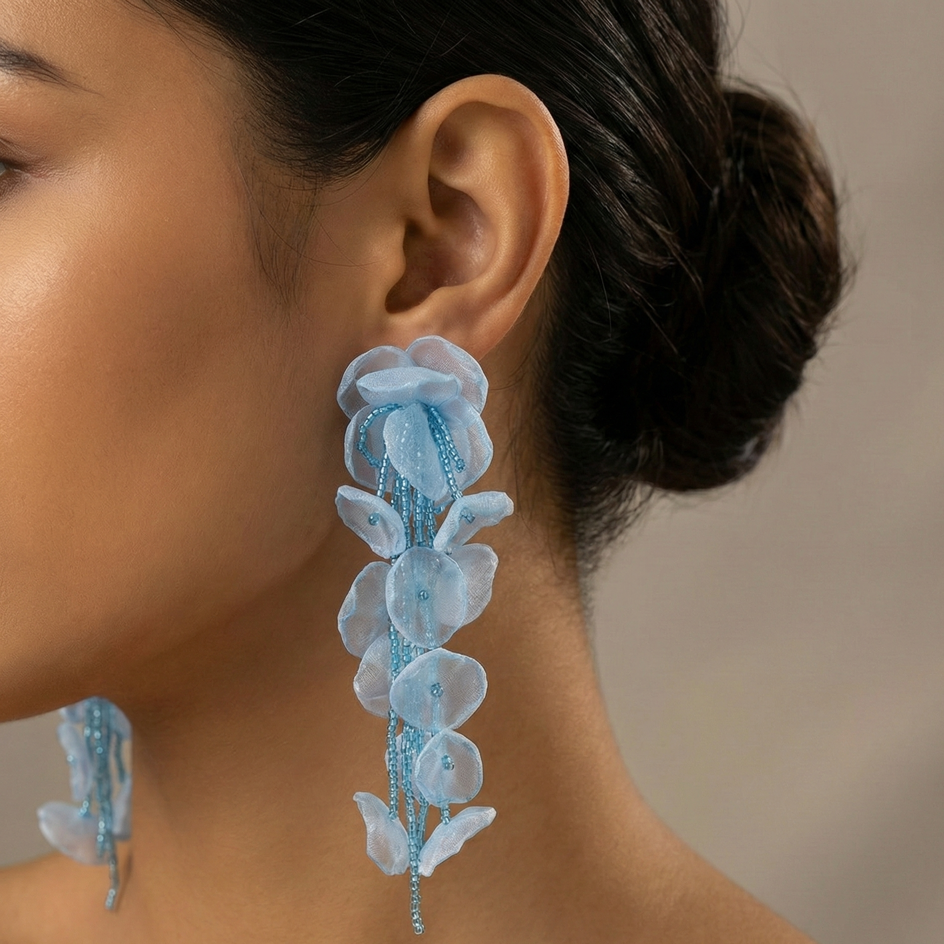 Close-up of a woman wearing blue floral earrings
